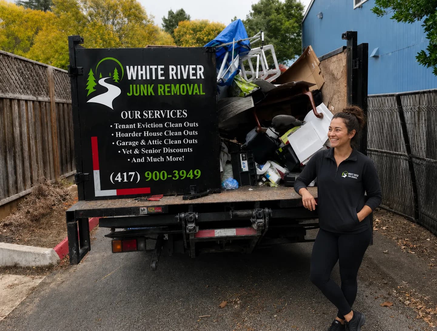 A trailer loaded with household furniture and boxes during a residential junk removal job